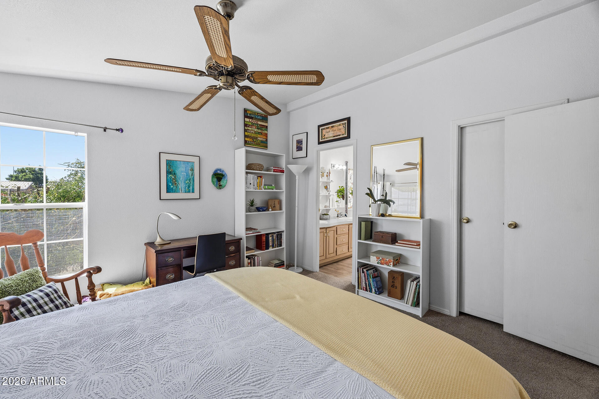 2701 East Utopia Road, Unit 153 Phoenix, AZ 85050 - Photo 21 of 26 a bedroom with a bed and a chandelier