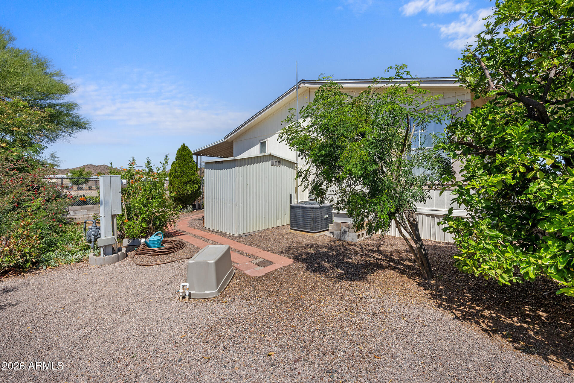 2701 East Utopia Road, Unit 153 Phoenix, AZ 85050 - Photo 25 of 26 a view of a chair and table in the garden