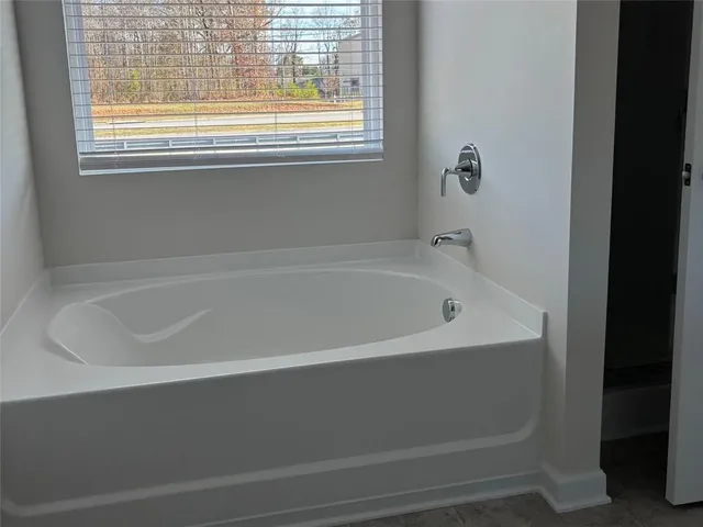 a white bath tub sitting next to a window