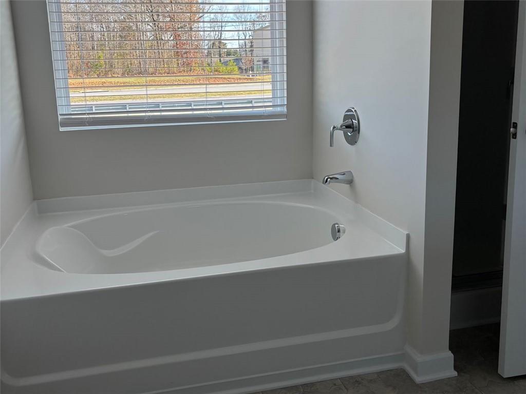 9440 Maple Grove Lane Jonesboro, GA 30238 - Photo 14 of 21 a white bath tub sitting next to a window
