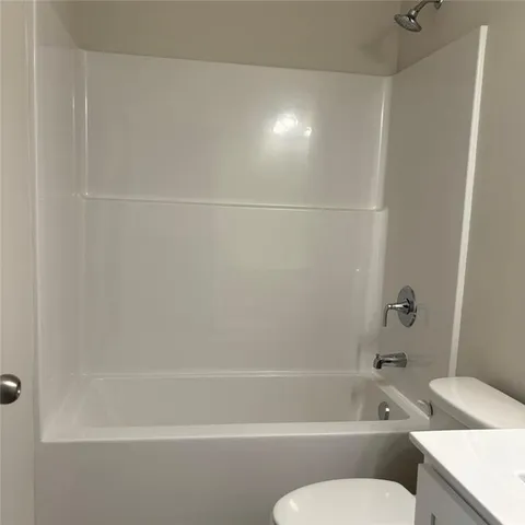a bathroom with a bathtub and a toilet