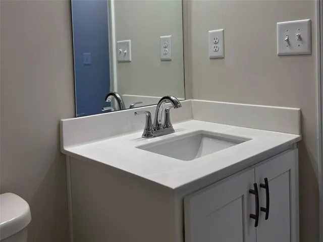 a close view of a sink and a toilet in a bathroom