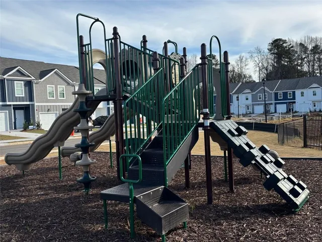 a view of a house with backyard water fountain and sitting area