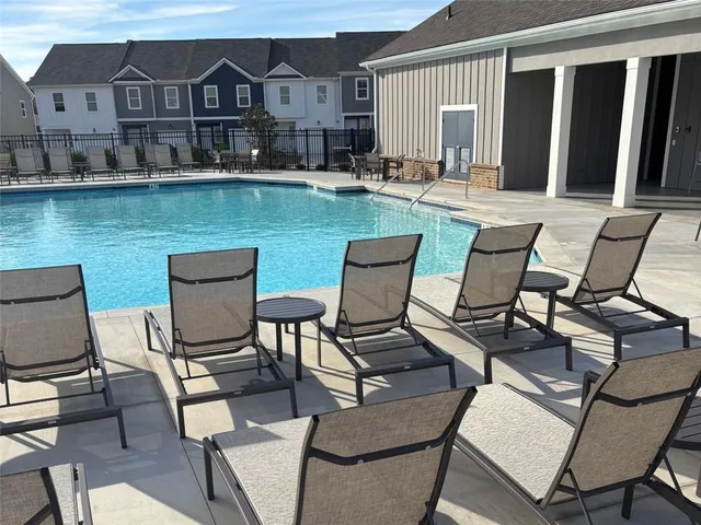 a view of a patio with couches chairs and potted plants