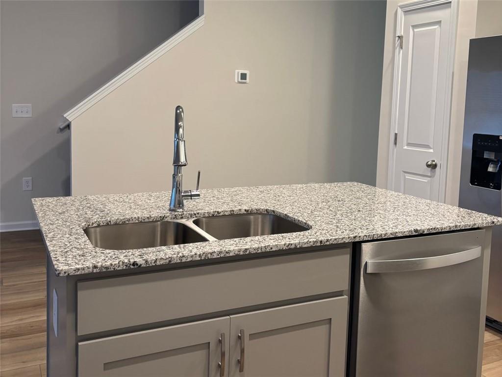 9440 Maple Grove Lane Jonesboro, GA 30238 - Photo 7 of 21 a kitchen with a granite countertop sink and refrigerator