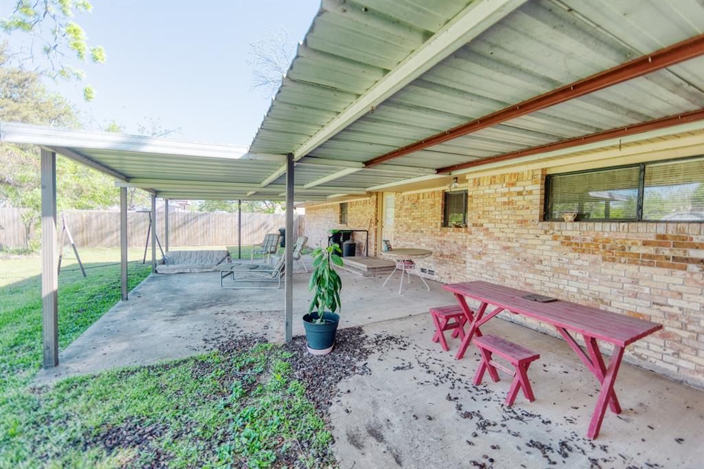 700 South Washington Street Pilot Point, TX 76258 - Photo 12 of 14 a view of a porch with furniture and a backyard