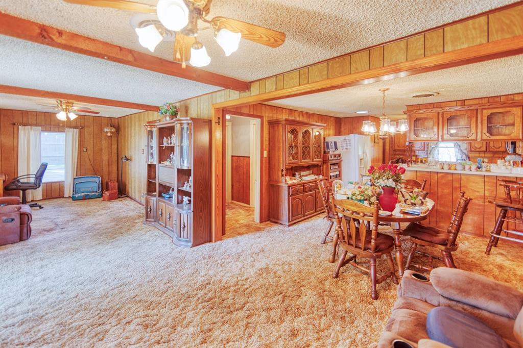 700 South Washington Street Pilot Point, TX 76258 - Photo 2 of 14 a view of a dining room with furniture and a chandelier