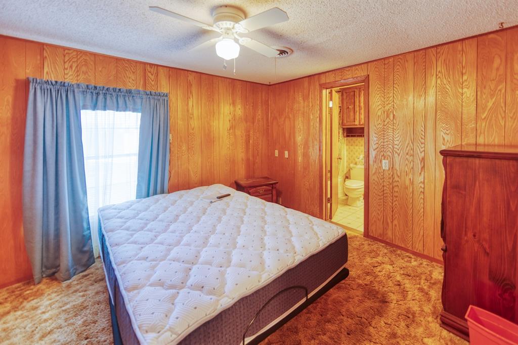 700 South Washington Street Pilot Point, TX 76258 - Photo 10 of 14 a bed room with a bed and a window