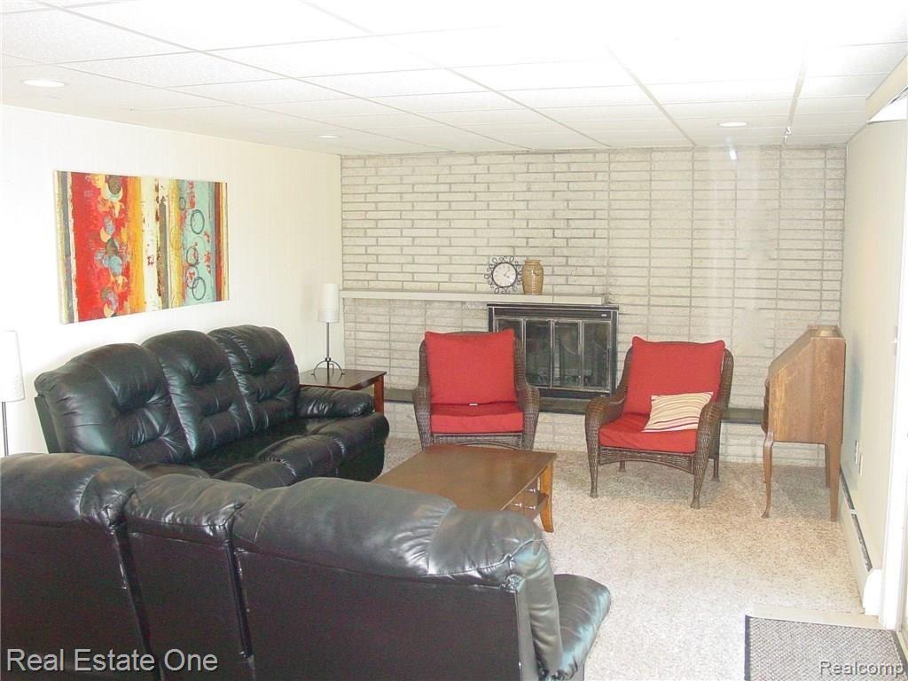 3875 East Commerce Road Commerce Township, MI 48382 - Photo 14 of 29 family room with fireplace