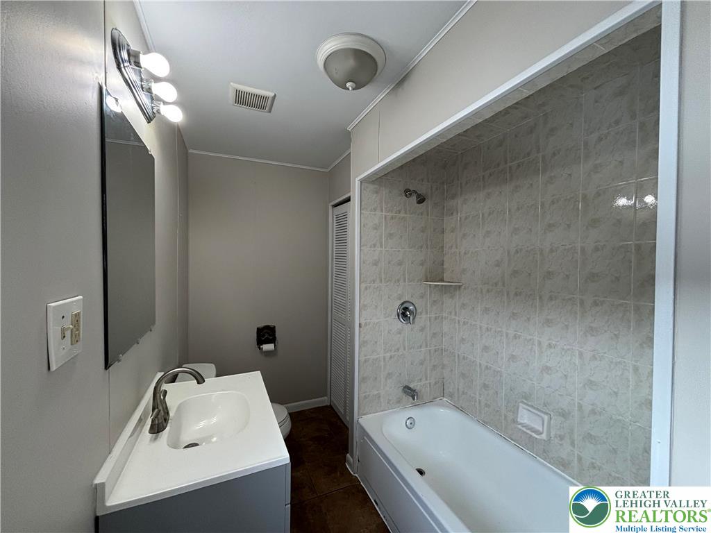 418 Ridge Street, Unit 2 Emmaus, PA 18049 - Photo 3 of 13 a bathroom with a tub sink toilet and mirror