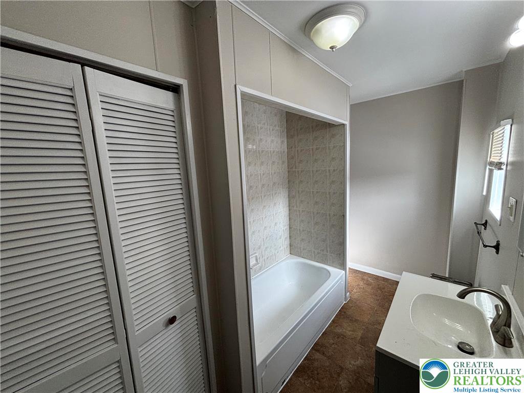 418 Ridge Street, Unit 2 Emmaus, PA 18049 - Photo 4 of 13 a bathroom with a tub and sink