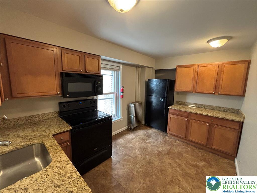 418 Ridge Street, Unit 2 Emmaus, PA 18049 - Photo 5 of 13 a kitchen with a refrigerator stove and microwave