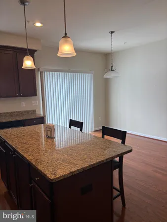 a view of a kitchen with a sink wooden floor and a chandelier