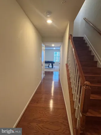 a view of a hallway view with wooden floor and staircase