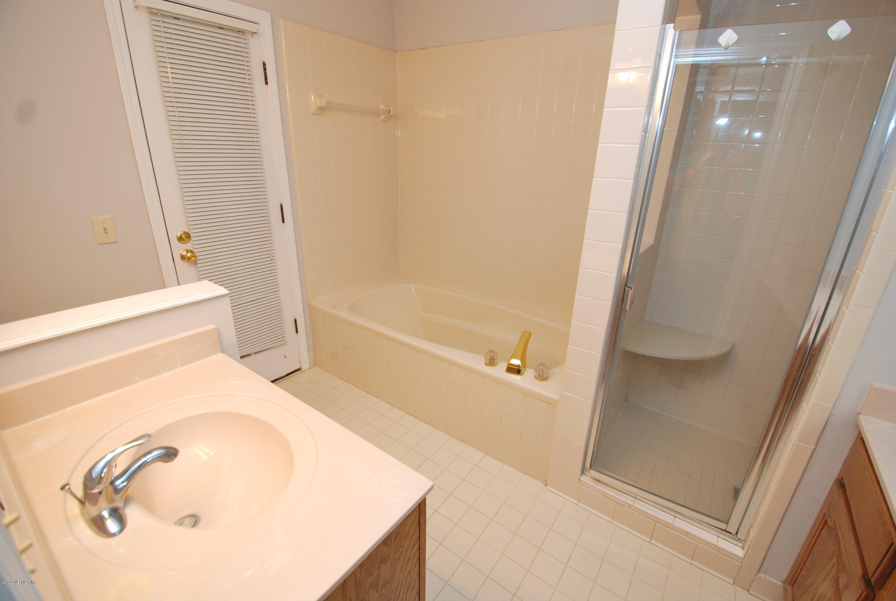 55581 Deer Run Road Callahan, FL 32011 - Photo 13 of 27 a bathroom with a bathtub and a shower
