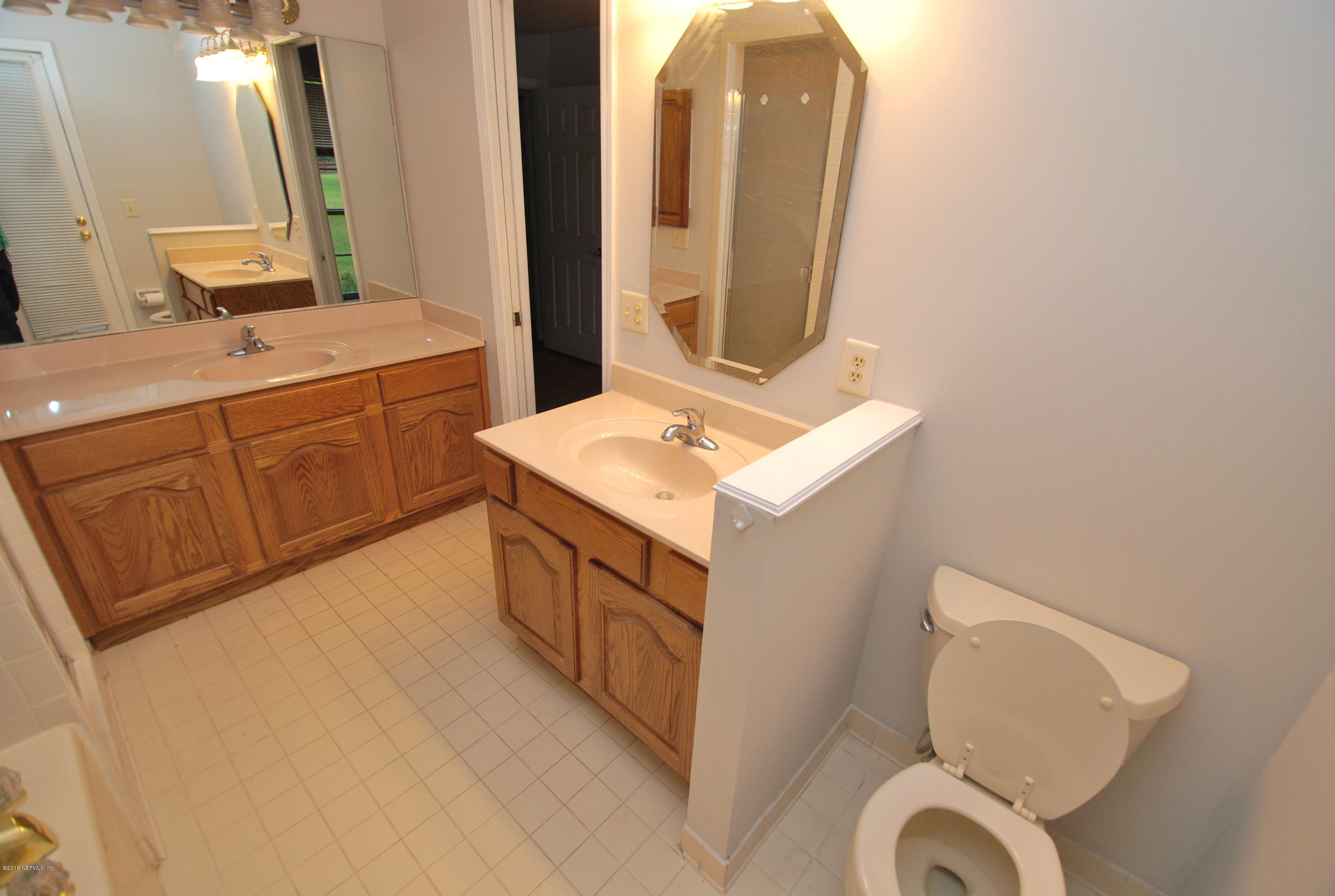 55581 Deer Run Road Callahan, FL 32011 - Photo 14 of 27 a bathroom with a sink a toilet and mirror