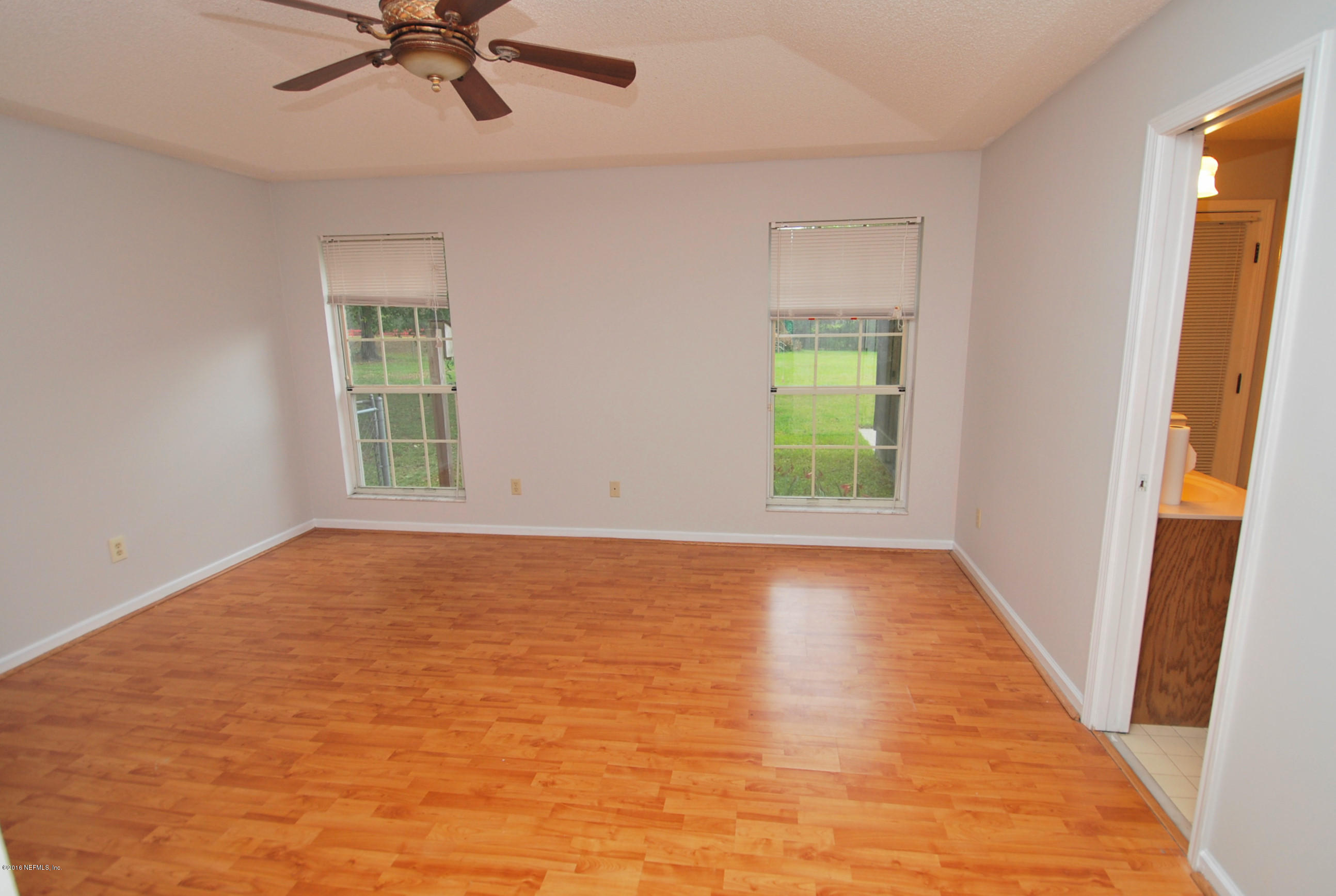 55581 Deer Run Road Callahan, FL 32011 - Photo 15 of 27 a view of an empty room with wooden floor and a window