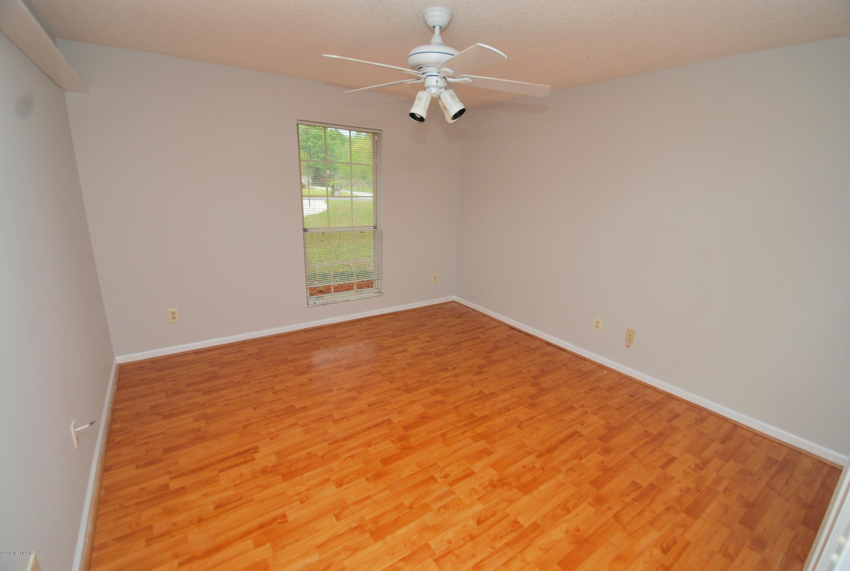 55581 Deer Run Road Callahan, FL 32011 - Photo 20 of 27 an empty room with windows and fan