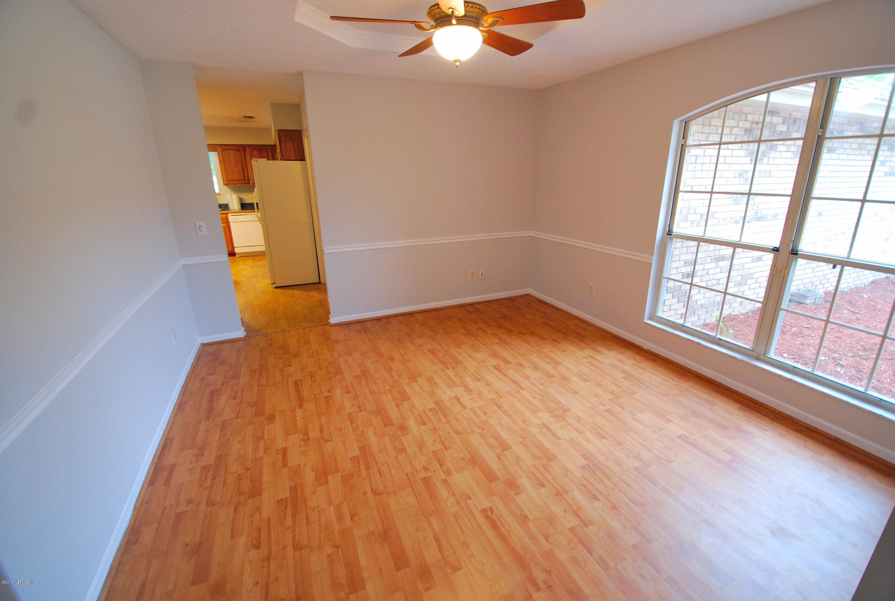 55581 Deer Run Road Callahan, FL 32011 - Photo 2 of 27 wooden floor in an empty room with a window