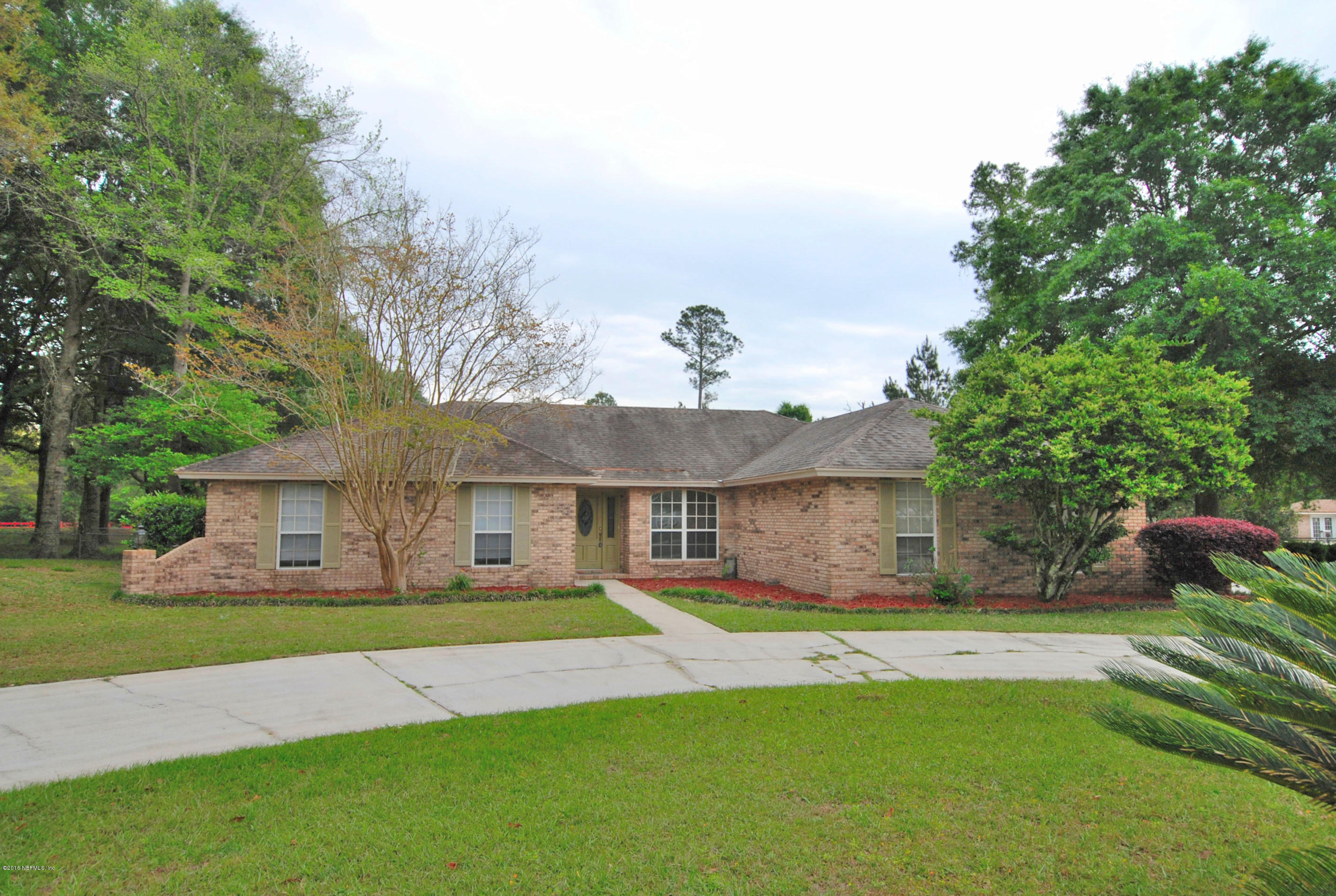 55581 Deer Run Road Callahan, FL 32011 - Photo 27 of 27 a front view of a house with a yard and potted plants