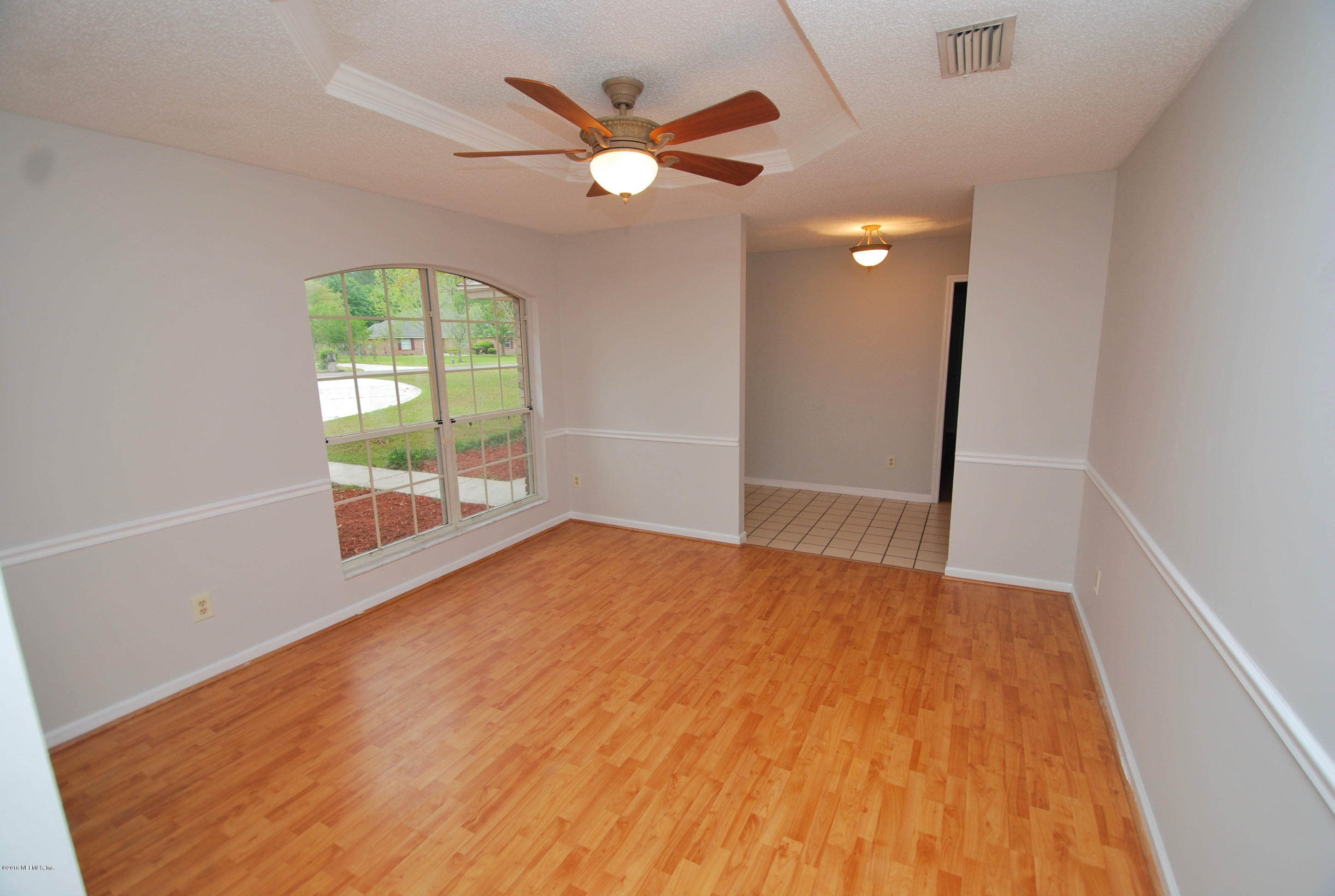 55581 Deer Run Road Callahan, FL 32011 - Photo 3 of 27 wooden floor in an empty room with a window