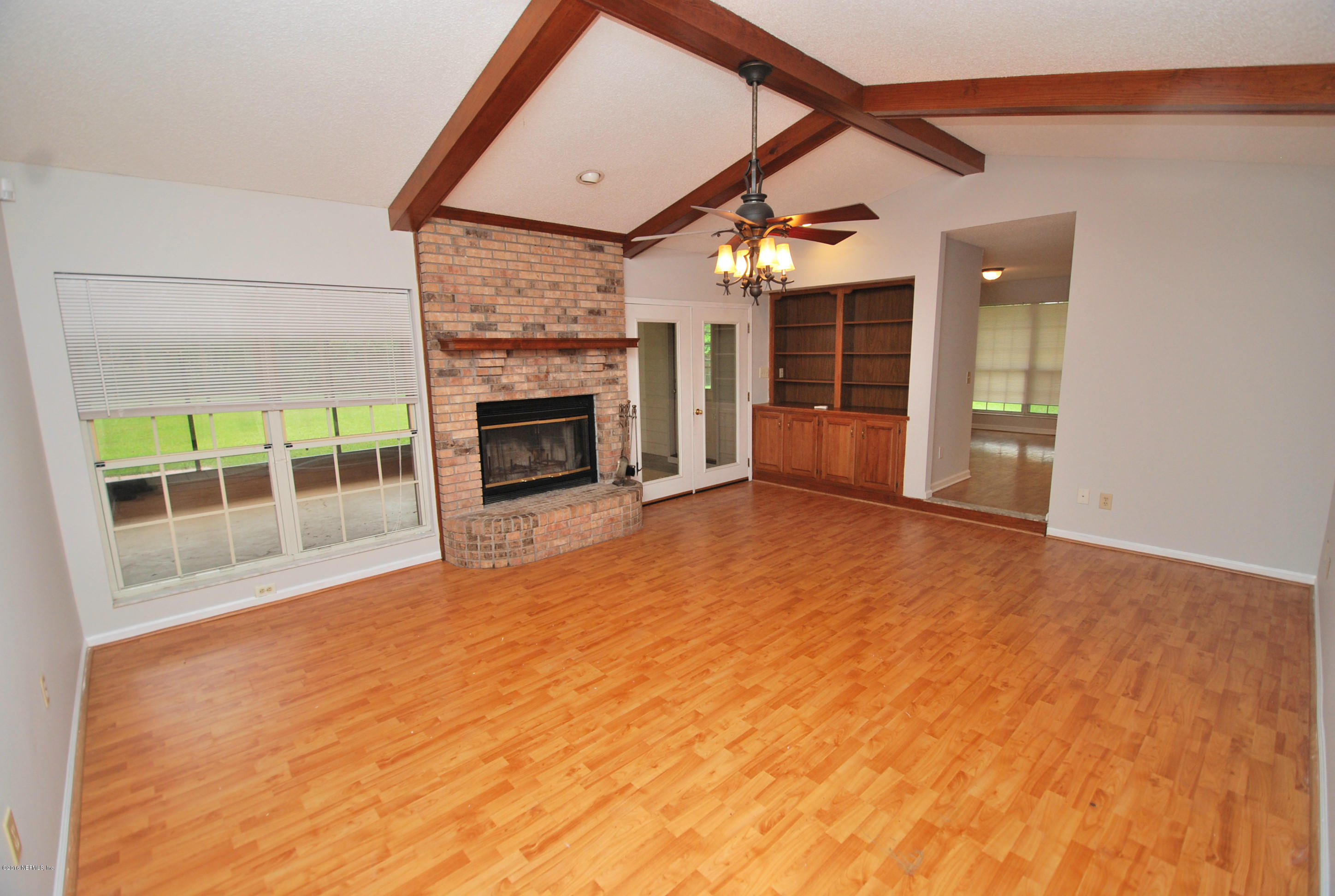 55581 Deer Run Road Callahan, FL 32011 - Photo 5 of 27 a view of an empty room with a fireplace and a window