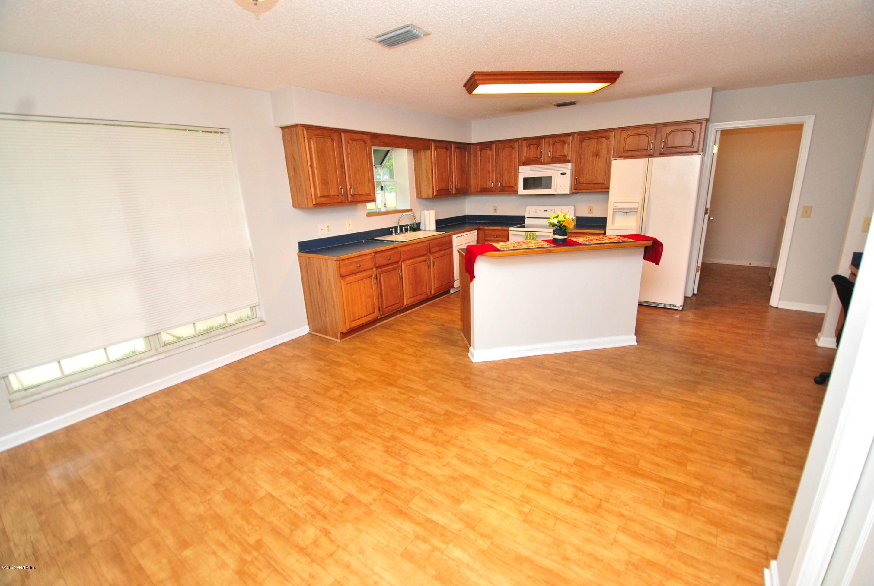 55581 Deer Run Road Callahan, FL 32011 - Photo 8 of 27 a large kitchen with stainless steel appliances granite countertop a stove a sink and a refrigerator