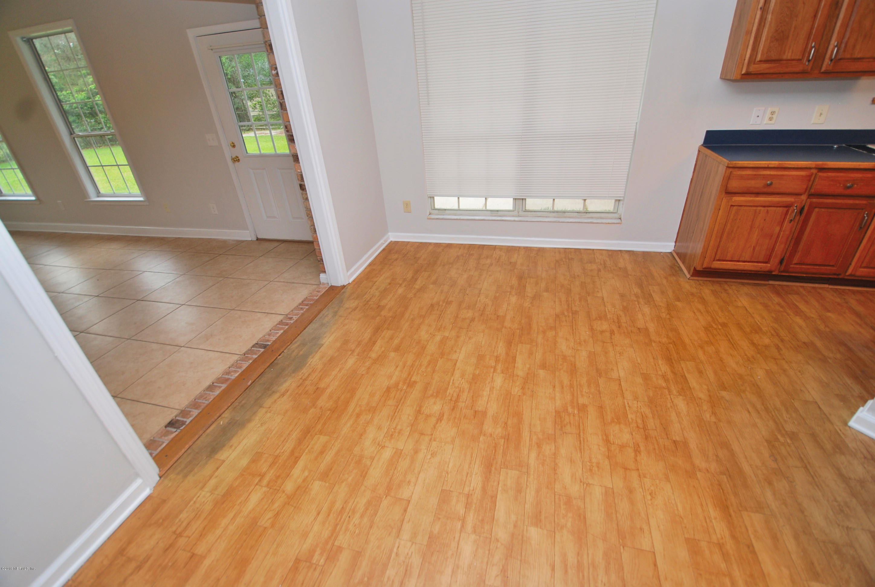 55581 Deer Run Road Callahan, FL 32011 - Photo 9 of 27 a view of empty room with window and wooden floor