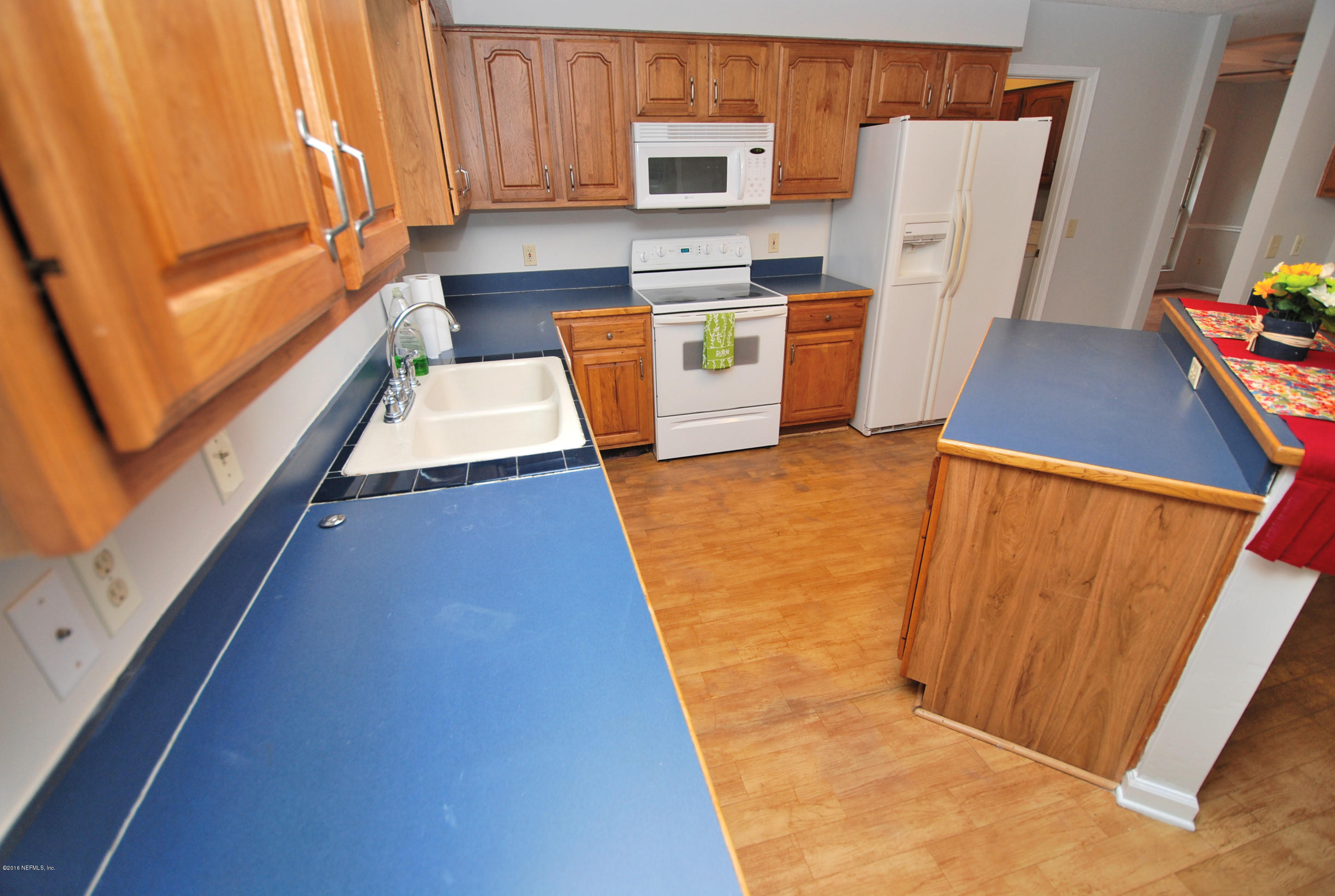 55581 Deer Run Road Callahan, FL 32011 - Photo 10 of 27 a view of a kitchen with refrigerator and microwave