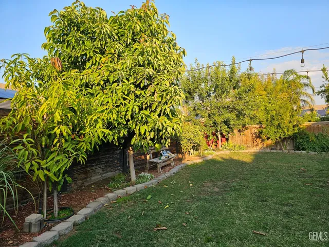 a view of a backyard with plants and a patio