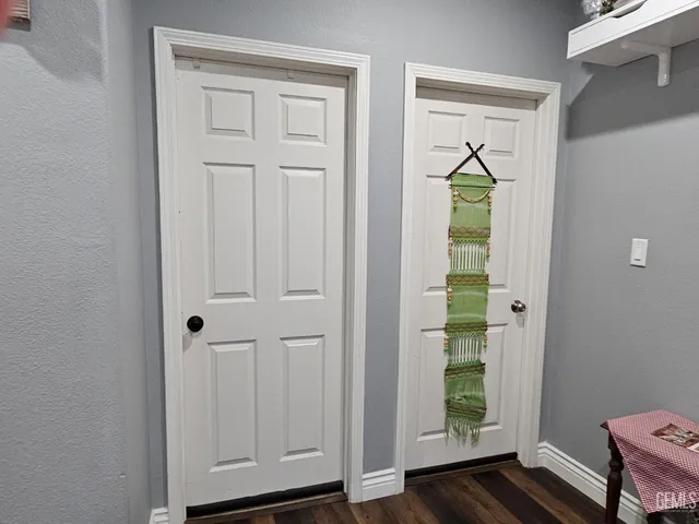 a bathroom with a granite countertop tub sink and mirror