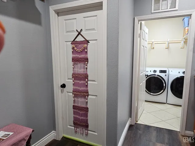a view of a hallway with furniture and wooden floor