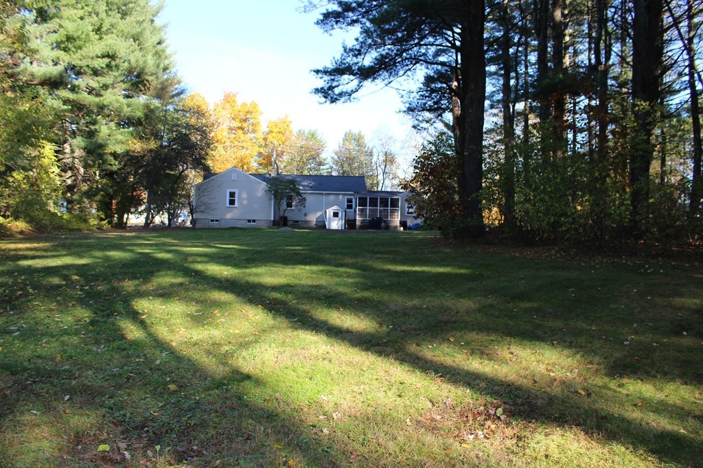 24 Garrison Road Chelmsford, MA 01824 - Photo 14 of 16 a view of a big yard with plants and large trees