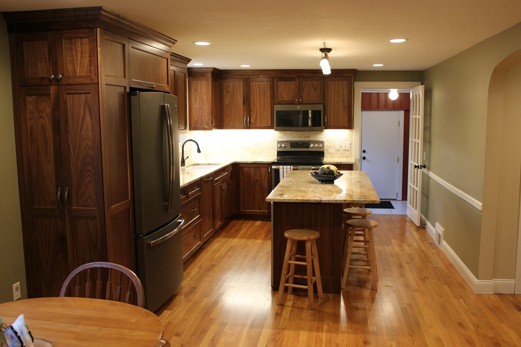 24 Garrison Road Chelmsford, MA 01824 - Photo 2 of 16 a kitchen with stainless steel appliances kitchen island granite countertop a refrigerator a stove a sink and a microwave with wooden floor