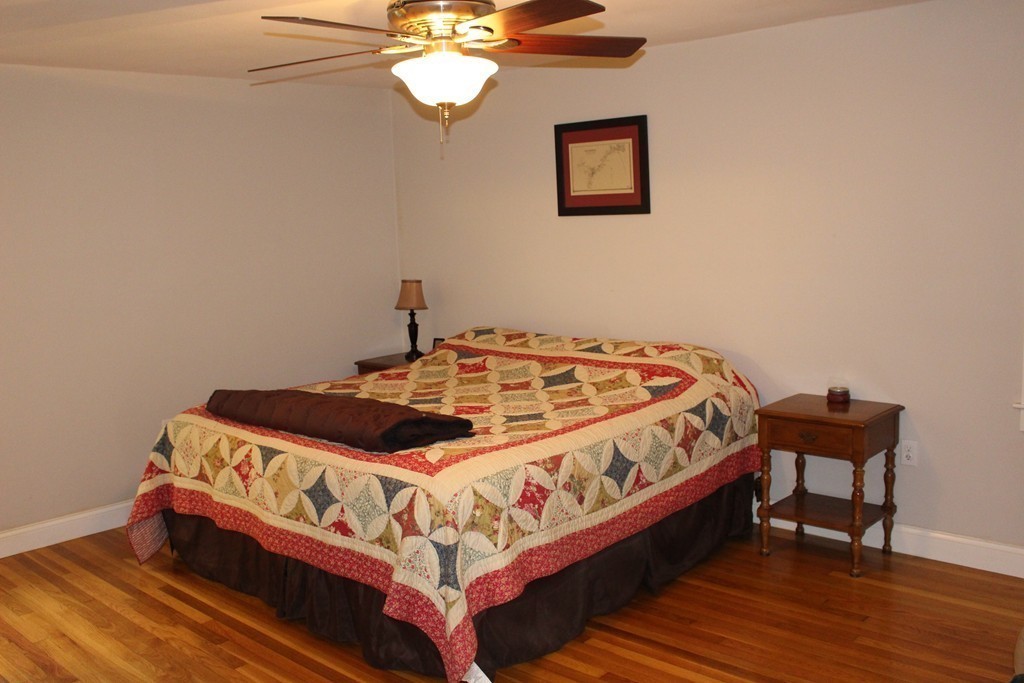 24 Garrison Road Chelmsford, MA 01824 - Photo 7 of 16 a bed sitting in a bedroom next to a lamp