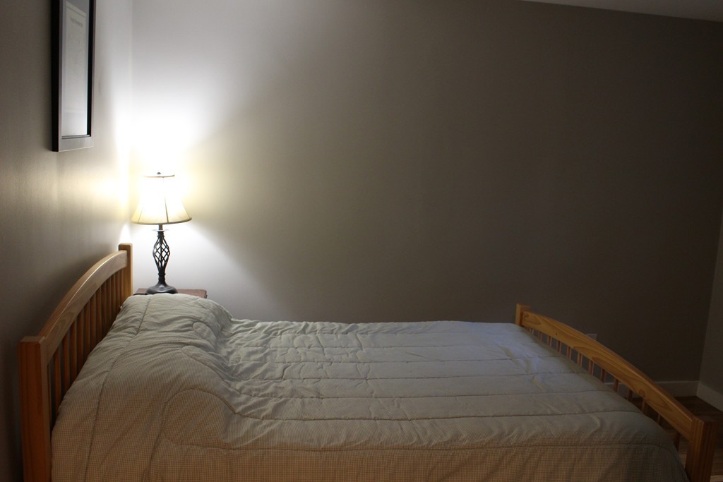 24 Garrison Road Chelmsford, MA 01824 - Photo 9 of 16 a bedroom with a bed and a lamp