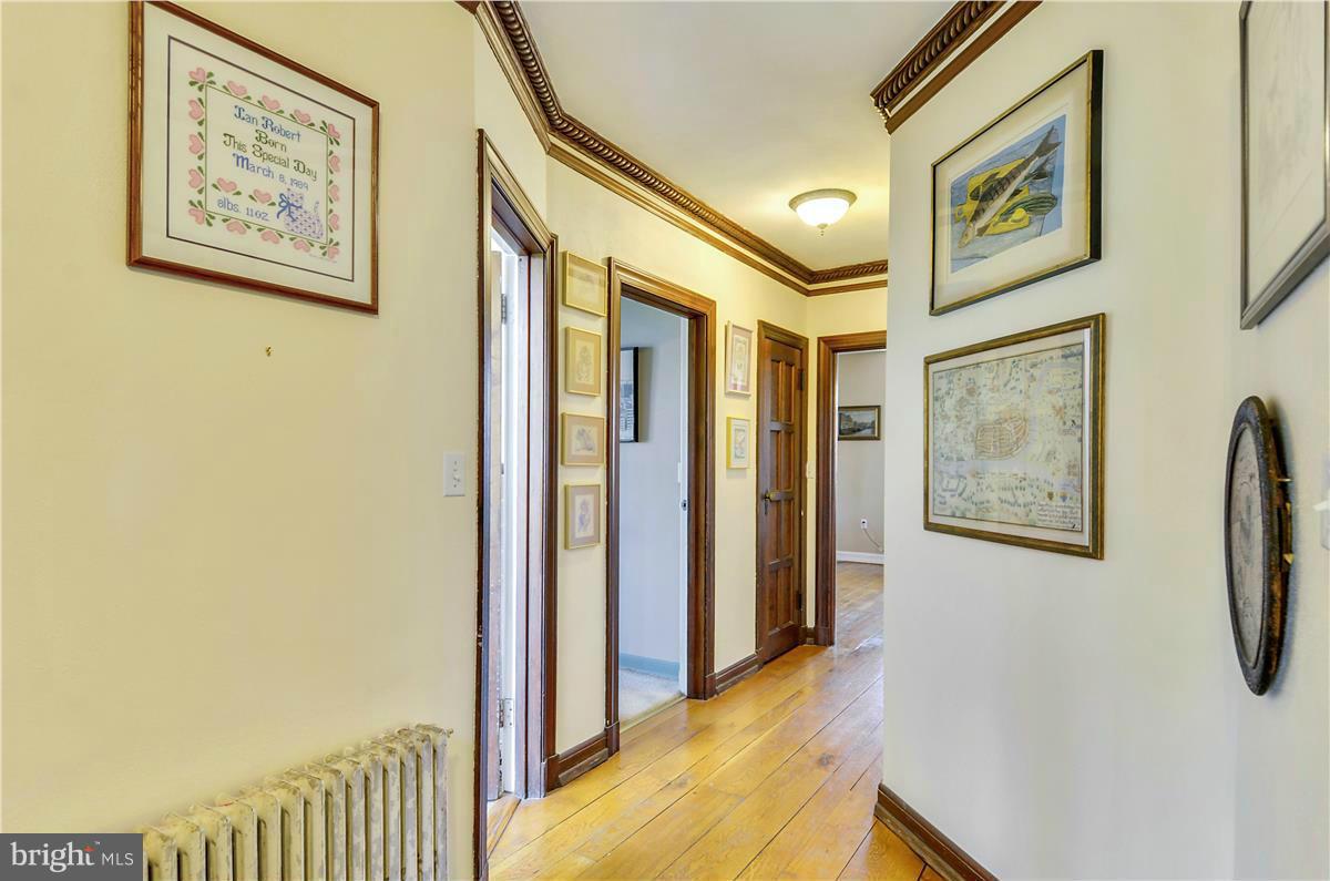 18505 Crossview Road Boyds, MD 20841 - Photo 8 of 30 a view of a hallway with paintings on the wall