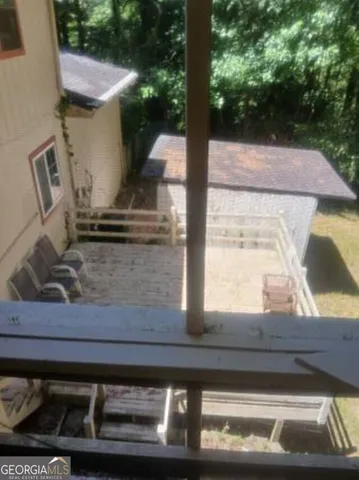 a view of a wooden house with a yard