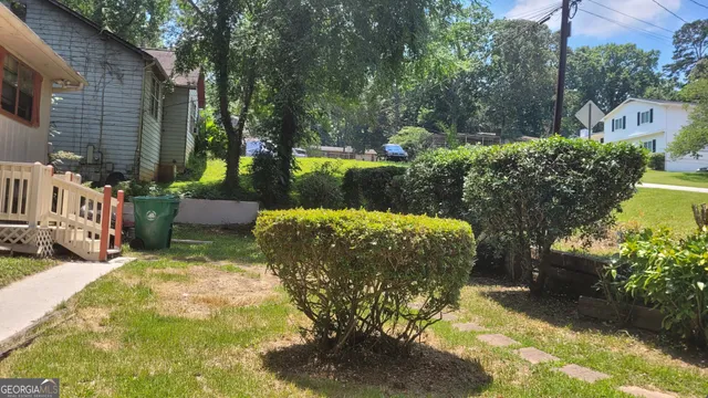 a view of a backyard with plants and patio