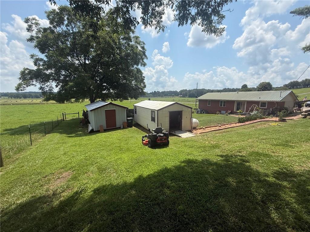 2705 Collard Valley Road Cedartown, GA 30125 - Photo 33 of 49 a view of a house with a yard potted plants and large tree