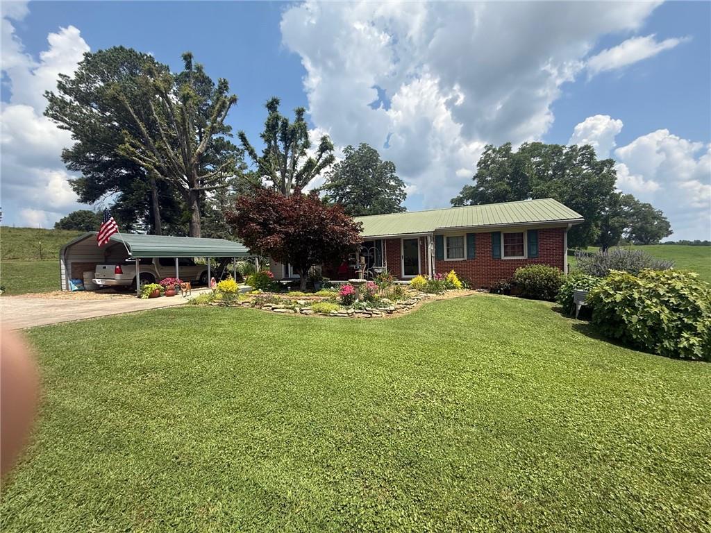 2705 Collard Valley Road Cedartown, GA 30125 - Photo 40 of 49 a front view of a house with garden and trees