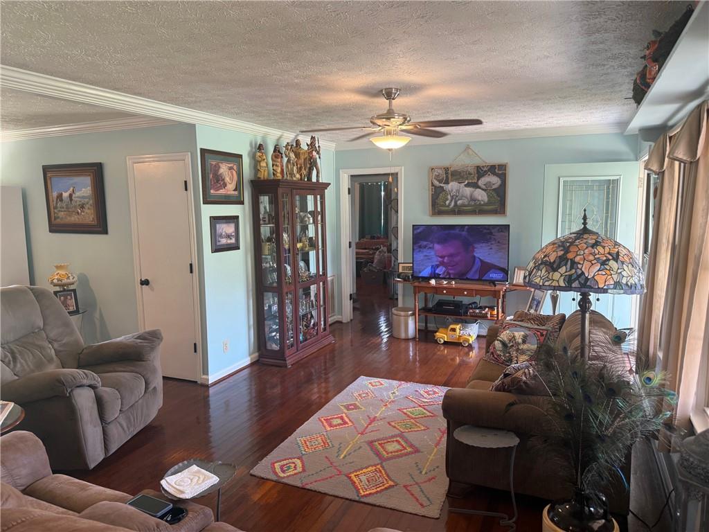 2705 Collard Valley Road Cedartown, GA 30125 - Photo 8 of 49 a living room with furniture a chandelier and a flat screen tv
