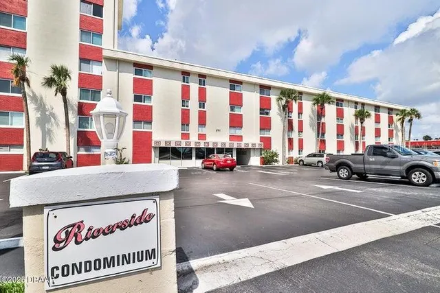 a view of a building with car parked