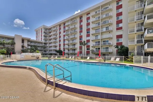 a swimming pool with outdoor seating and yard