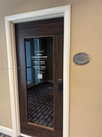 a dining room with furniture a potted plant and wooden floor