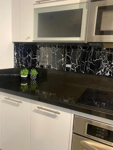 a view of a storage and utility room with washer and dryer