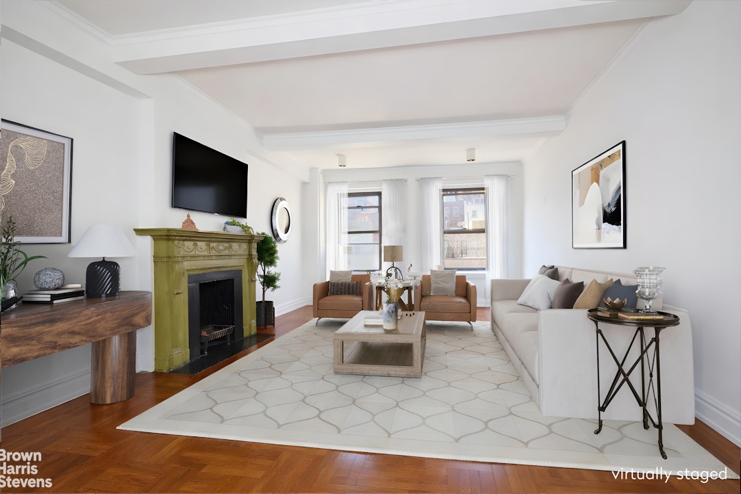 a living room with furniture a flat screen tv and a fireplace