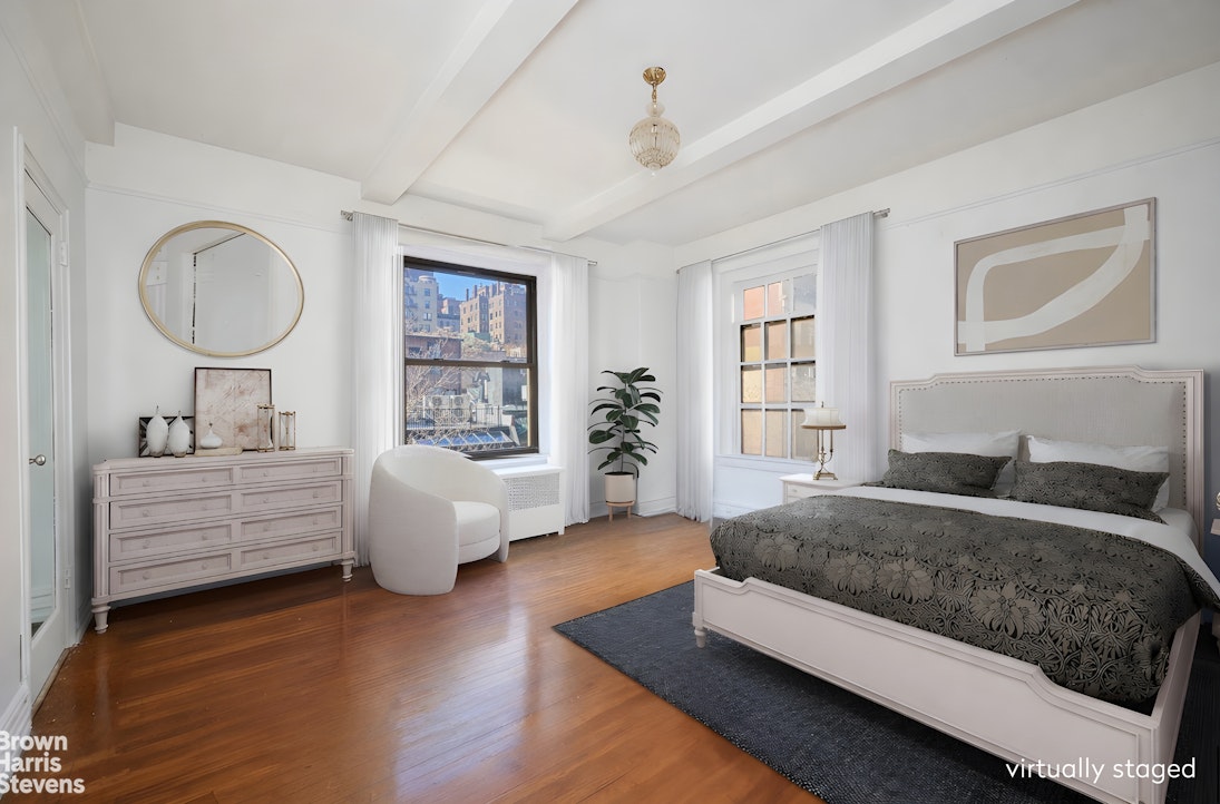 135 East 74th Street, Unit 6A Manhattan, NY 10021 - Photo 3 of 9 a spacious bedroom with a large bed and windows