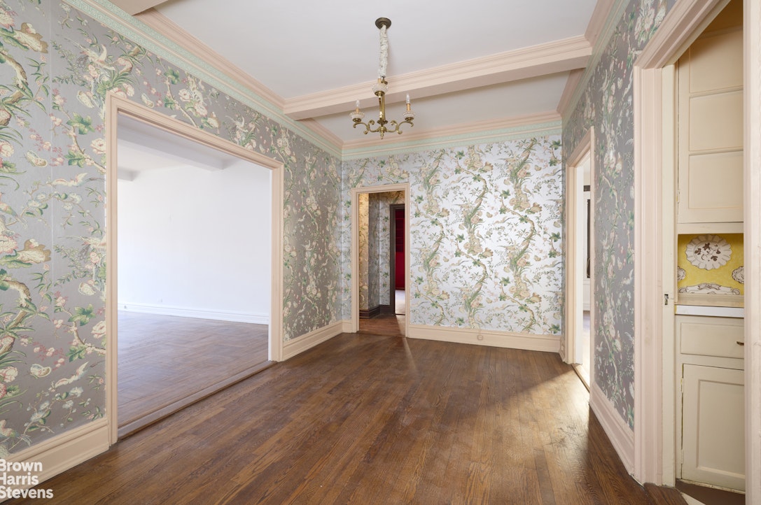 135 East 74th Street, Unit 6A Manhattan, NY 10021 - Photo 6 of 9 a view of a hallway with wooden floor and staircase