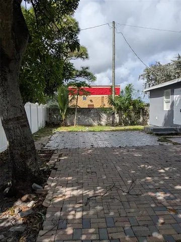 a backyard of a house with a fountain and a fireplace